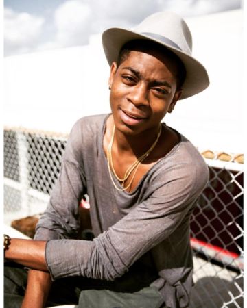 RJ Cyler is posing for the photo.